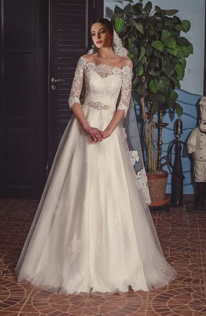 ---Romantic A-line wedding dress made of semi-sheer lace bodice with half sleeves, satin lining and long tulle skirt with lace a